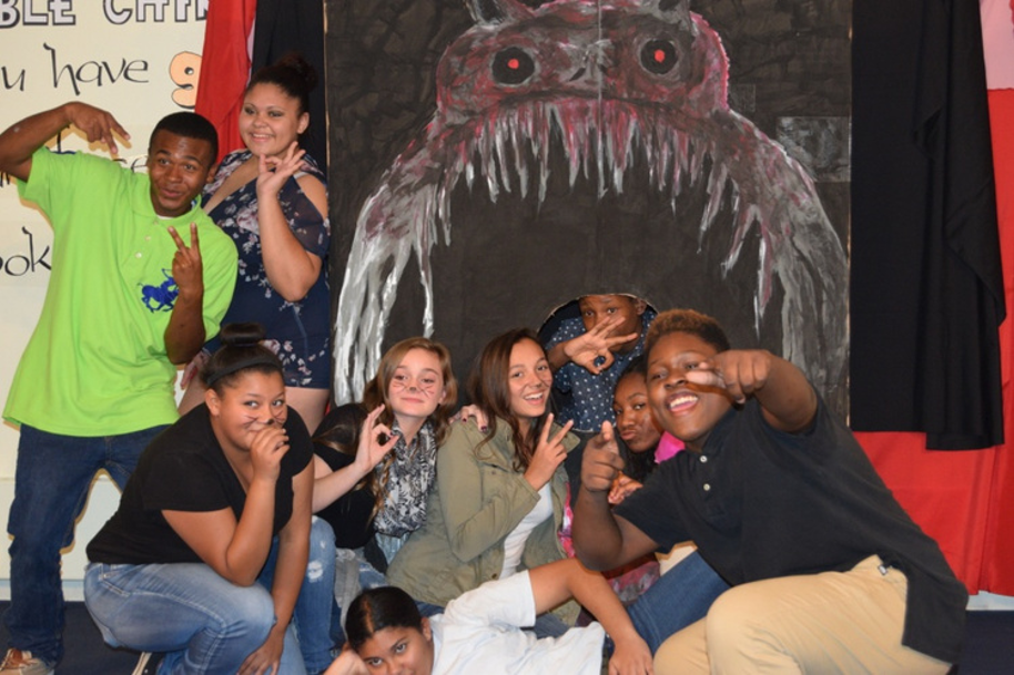 Teens posing during Halloween event in the library