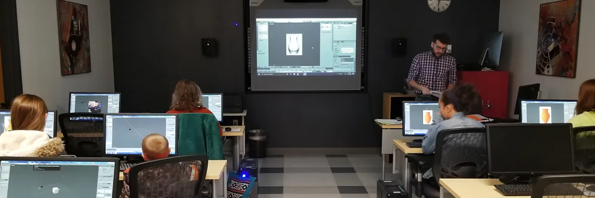 Tech Training header showing showing people sitting in front of desktop computers watching a demonstration at the front of the room