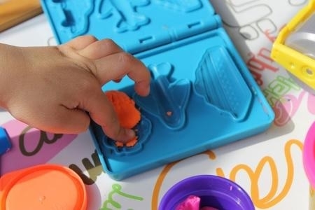 child playing with play dough