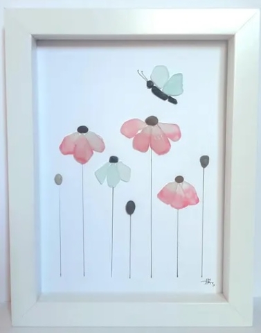 White Shadow Box Frame showing 4 flowers and a butterfly composed from colored sea glass