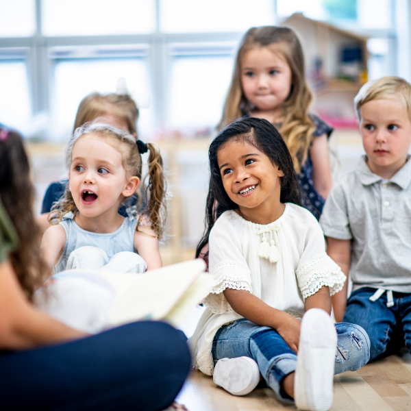 Group of young children sitting on the floor for storytime