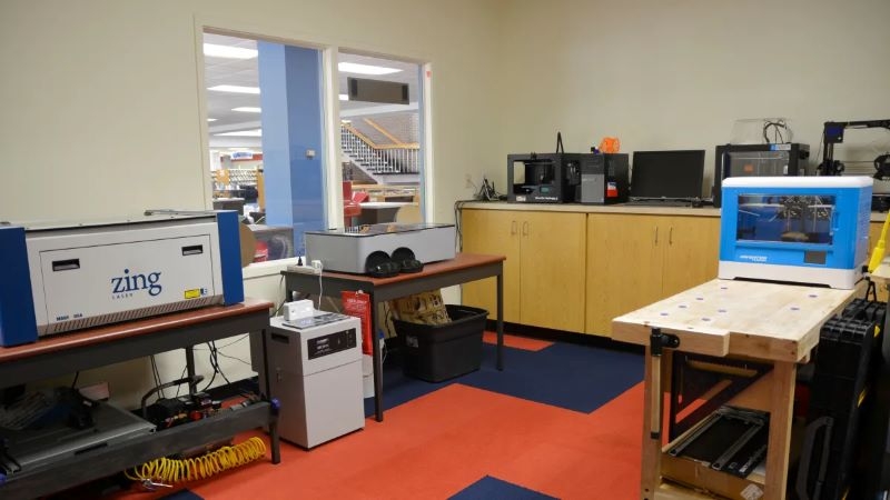 Photo of Tinker Lab space showcasing laser cutting, 3d printing, and other equipment.