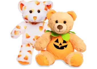 Two Halloween bears, one with candy corn and one with a Jack-o-lantern.