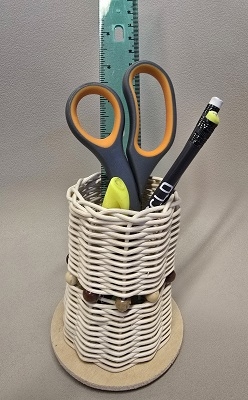 Reed woven basket being used as a pencil holder.